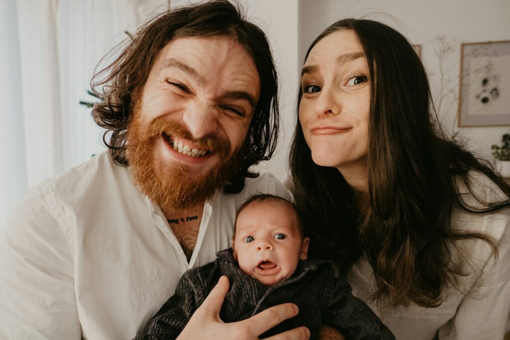 Parents holding their newborn baby at home