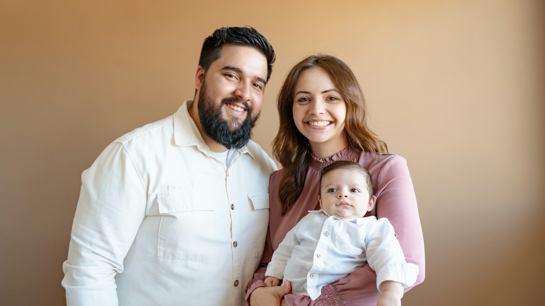 Happy brown-skinned parents with their newborn baby