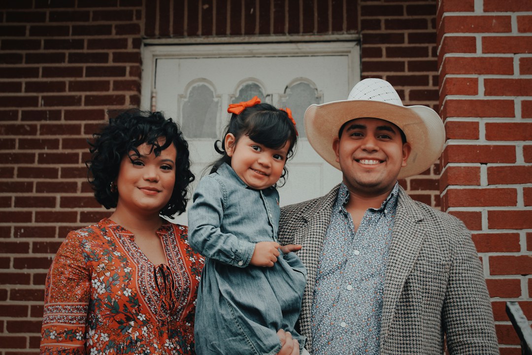 Happy diverse family smiling with their toddler