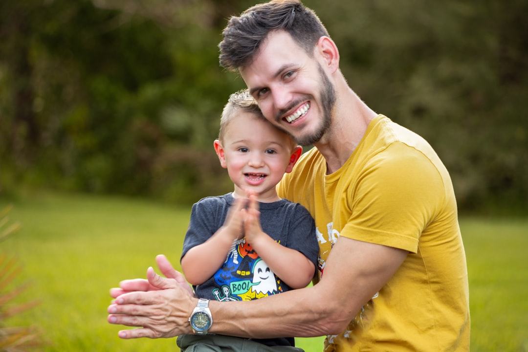 Happy father and young son smiling outdoors