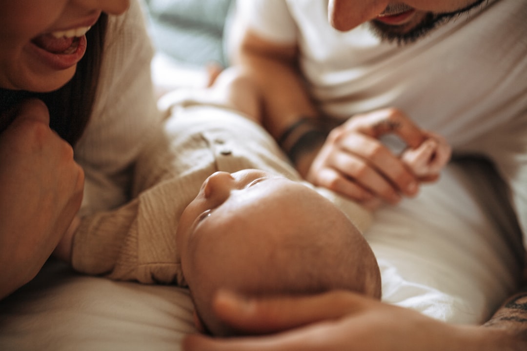 Happy mother and father holding their newborn baby together in a bright home