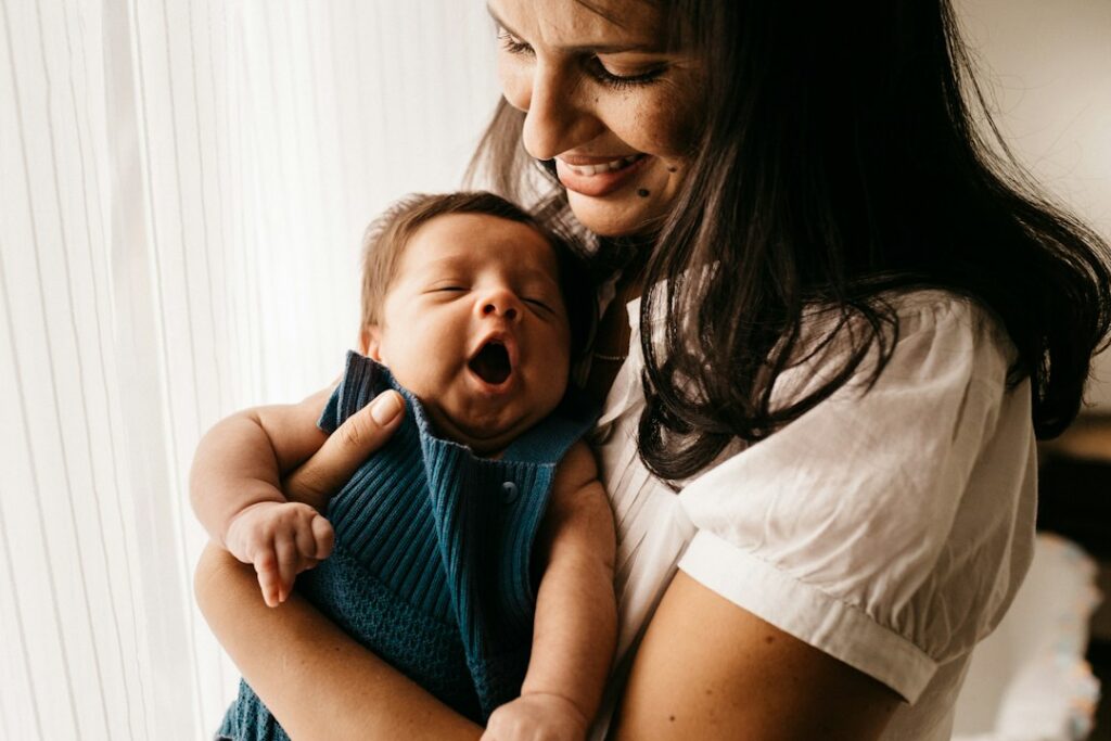 Parent holding a baby in a comfortable home setting