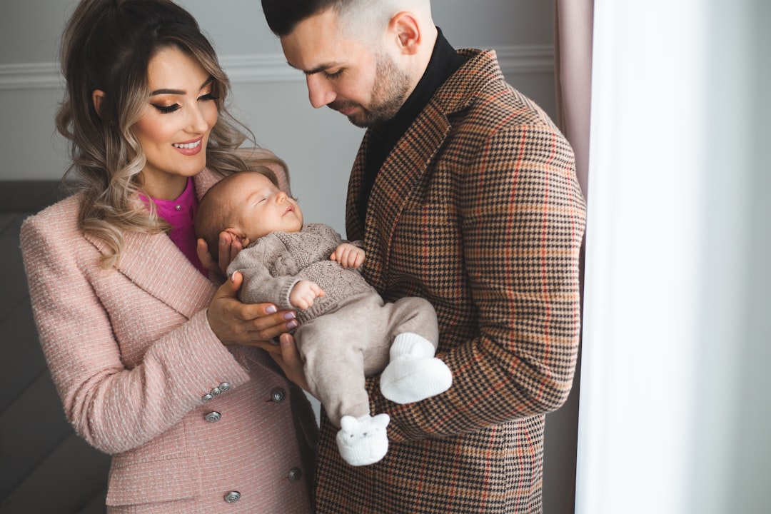 Parents gently holding their newborn baby at home