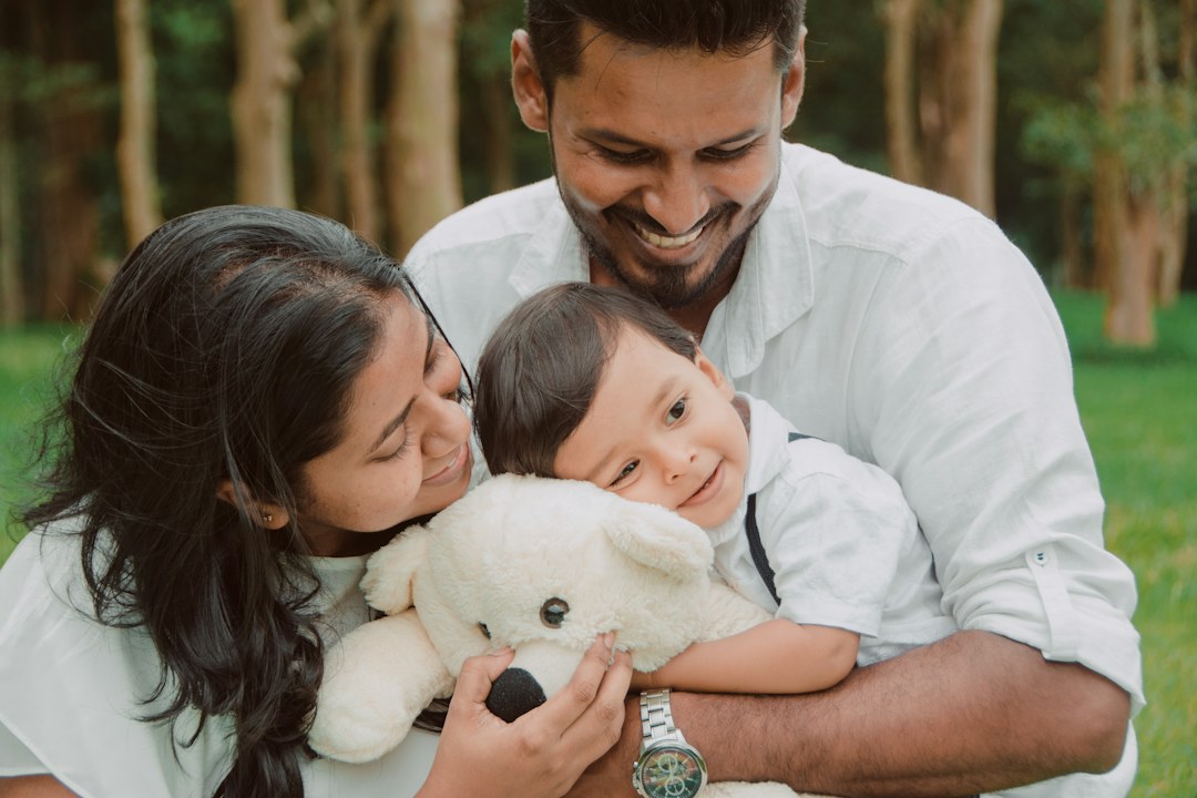 Happy South Asian parents holding their baby
